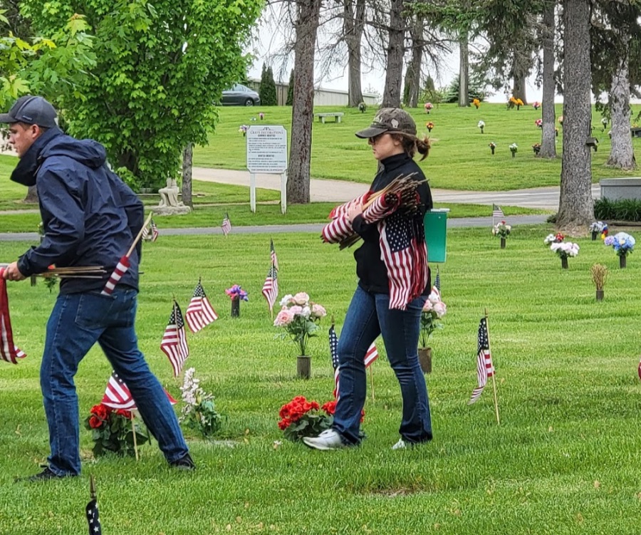 Volunteers placing flags on veterans’ graves.